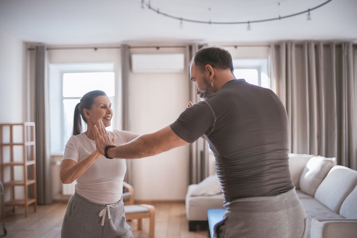Two people working through a movement together at home.